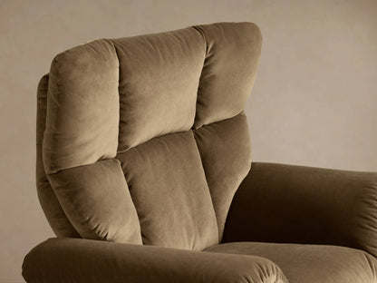 Close-up view of the brown Deacon Swivel Recliner's plush armrest and side, with a silver reclining lever.