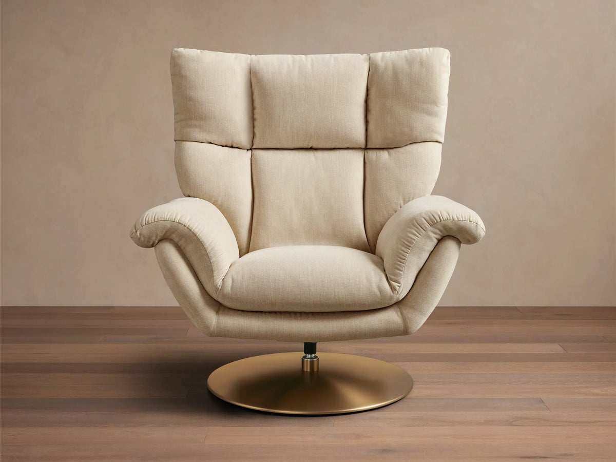 Front view of the cream Deacon Swivel Recliner, showing its plush tufted backrest, padded rolled arms, and round gold swivel base.