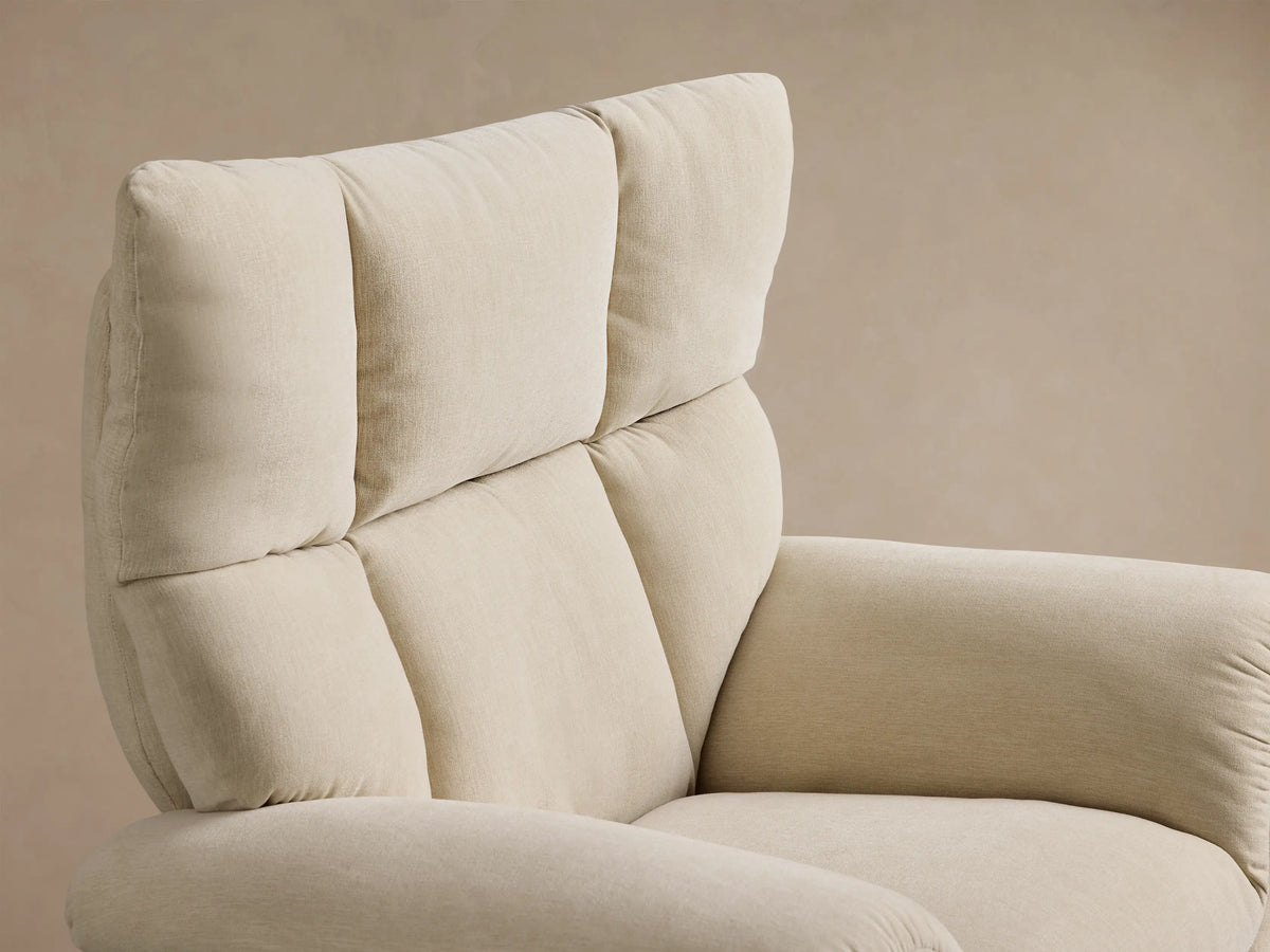 Front view of the Cream Deacon Swivel Recliner with a tufted backrest, rolled arms, and a round gold swivel base.