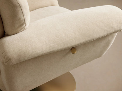 Close-up of the light cream Deacon Swivel Recliner, showing its plush, segmented backrest and armrest from a side angle.