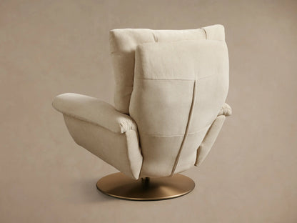 Close-up of the armrest on the beige Deacon Swivel Recliner, showing textured fabric, a brass side lever, and gold swivel base.