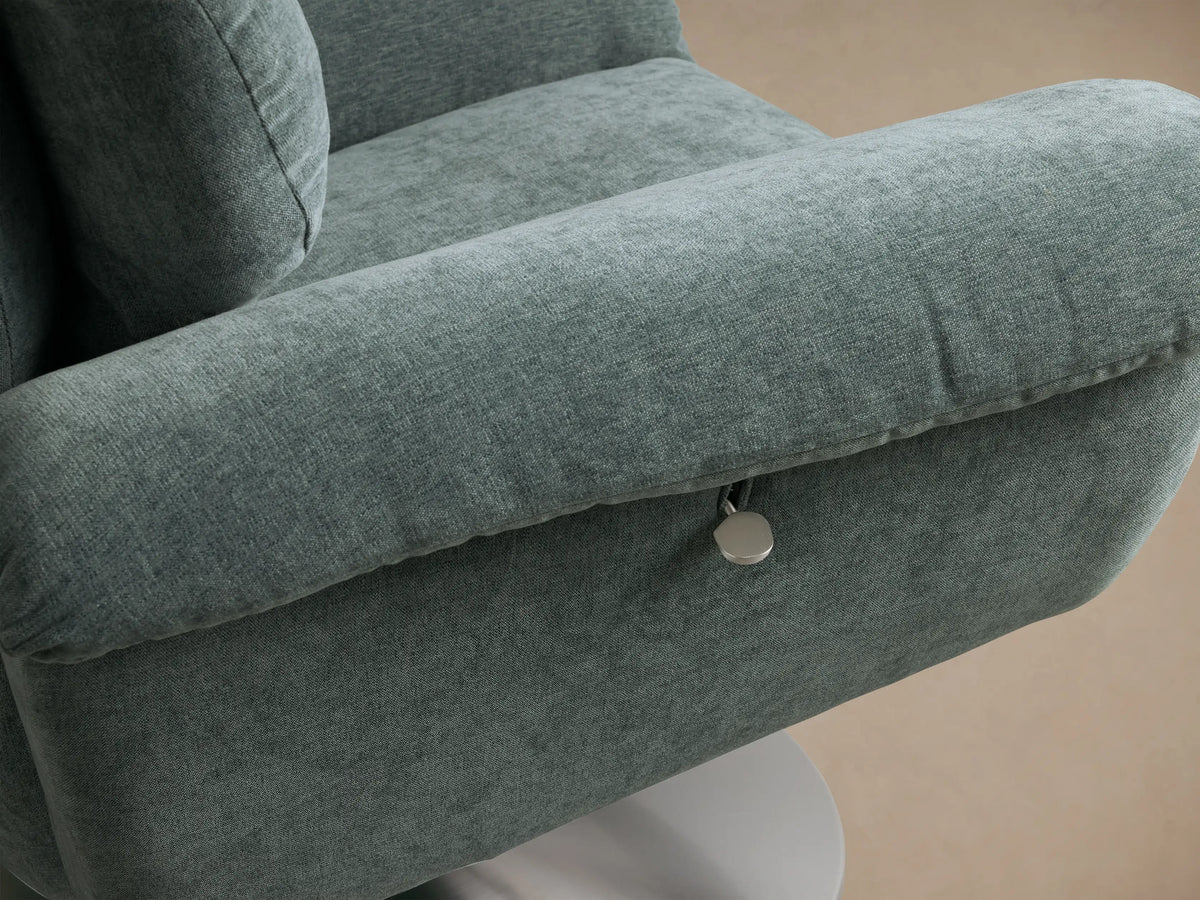Close-up of the muted teal Deacon Swivel Recliner, showing the vertically channeled backrest and arm.