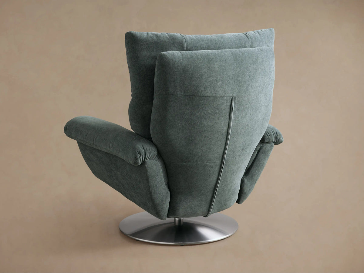 Close-up of the muted teal woven fabric armrest on the Deacon Swivel Recliner, revealing a small silver side lever.