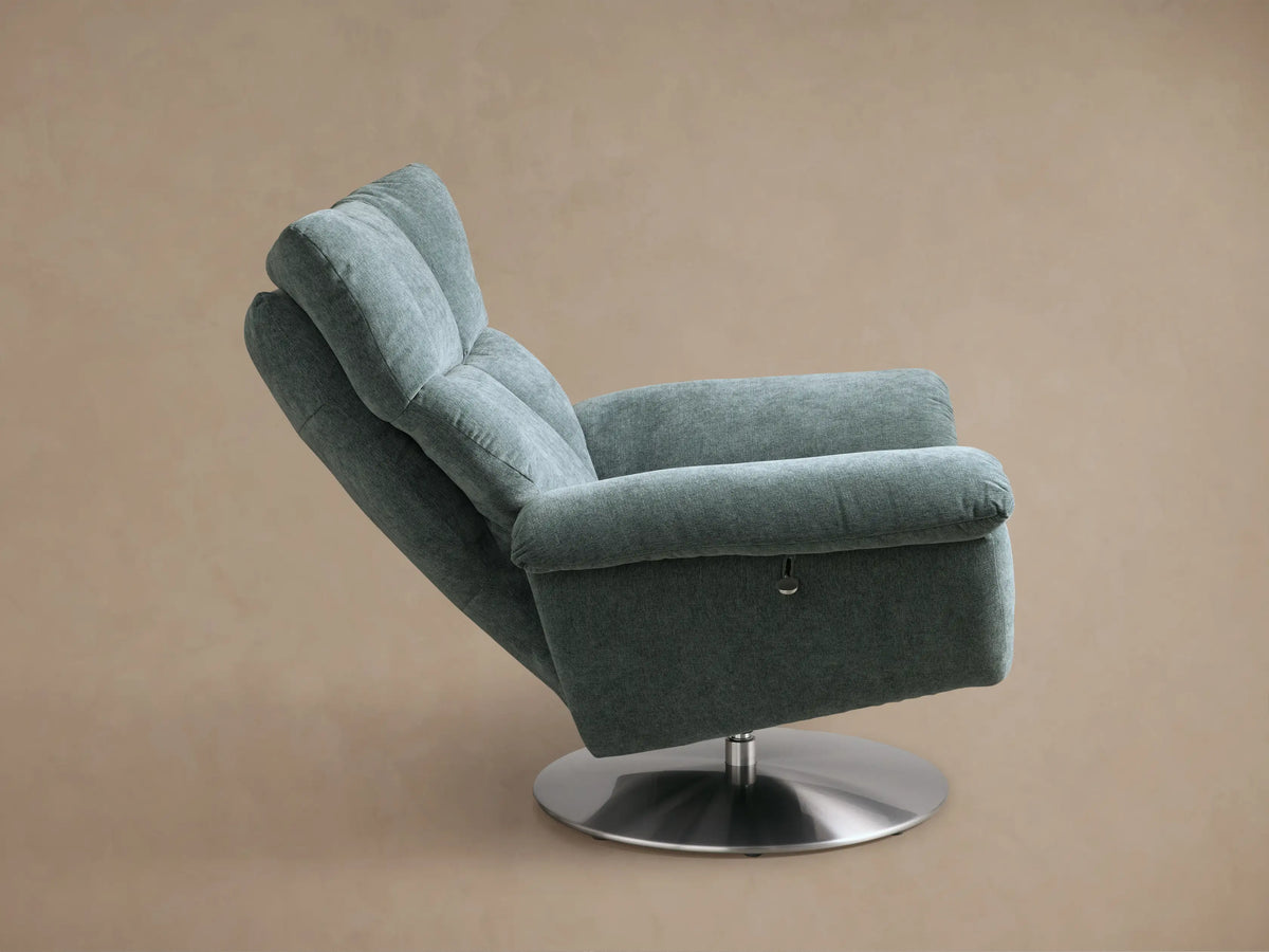 Rear view of the deep sage green Deacon Swivel Recliner with a brushed metal swivel base and textured fabric.