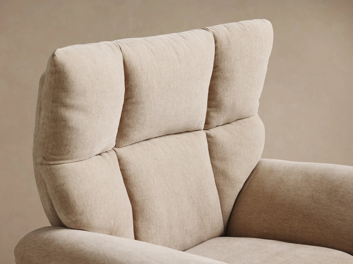 Front view of the beige Deacon Swivel Recliner with a tufted back, plush rolled arms, and a gold swivel base.