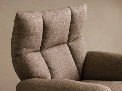 Close-up of the brown woven fabric on the multi-paneled backrest and curved armrest of the Deacon Swivel Recliner.