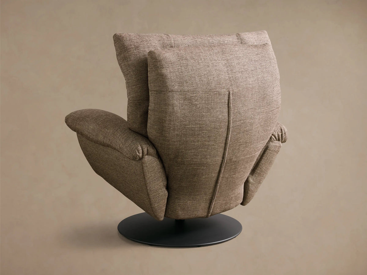 Close-up of the brown textured armrest and side of the Deacon Swivel Recliner, showing the silver reclining lever.
