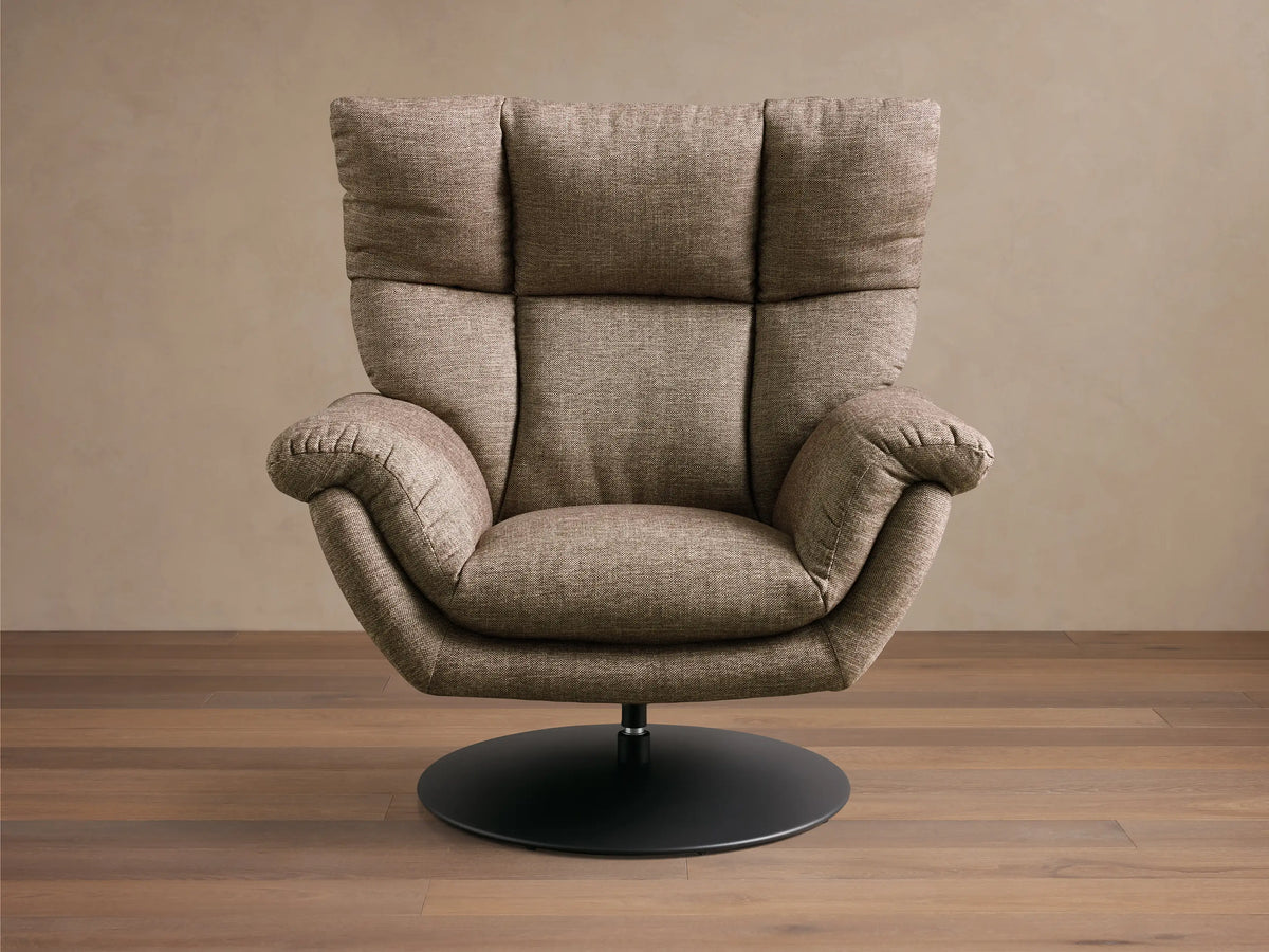 Rear view of the taupe Deacon Swivel Recliner, showing its textured fabric, vertical back seam, and black circular swivel base.