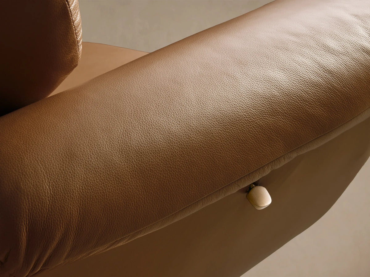 Front view of the tan Deacon Leather Swivel Recliner with a padded back, plush armrests, and a golden swivel base.
