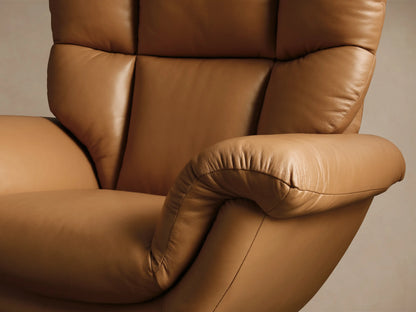 Close-up of the brown textured leather armrest and small metallic lever of the Deacon Leather Swivel Recliner.