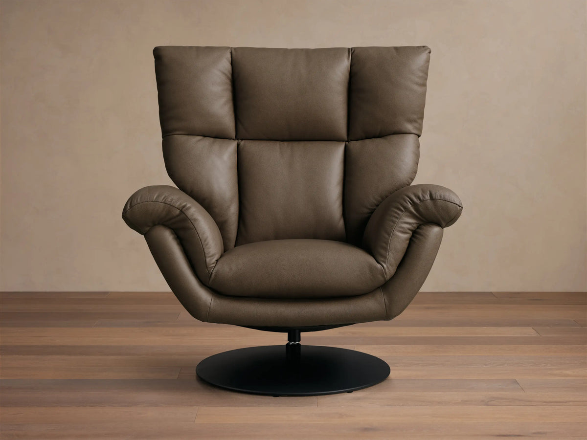 Front view of the Taupe Deacon Leather Swivel Recliner, featuring a plush, sectioned back, rolled armrests, and a black circular base.