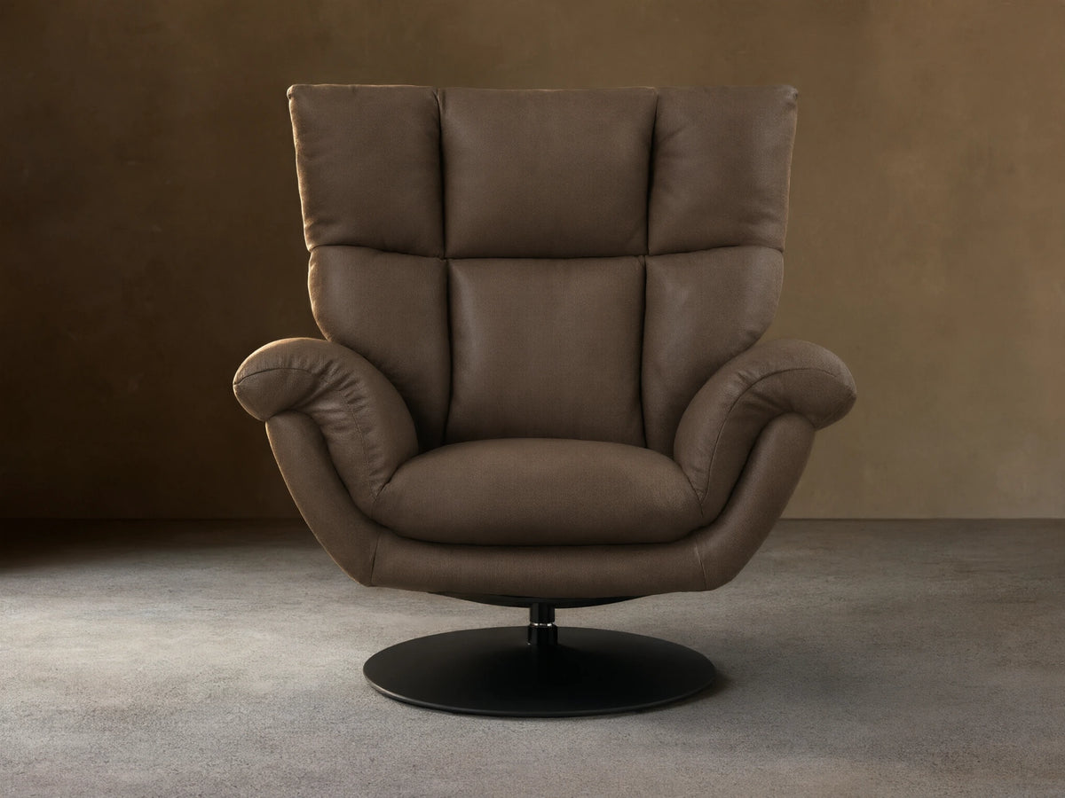 Front view of the Taupe Deacon Leather Swivel Recliner, featuring a plush, sectioned back, rolled armrests, and a black circular base.