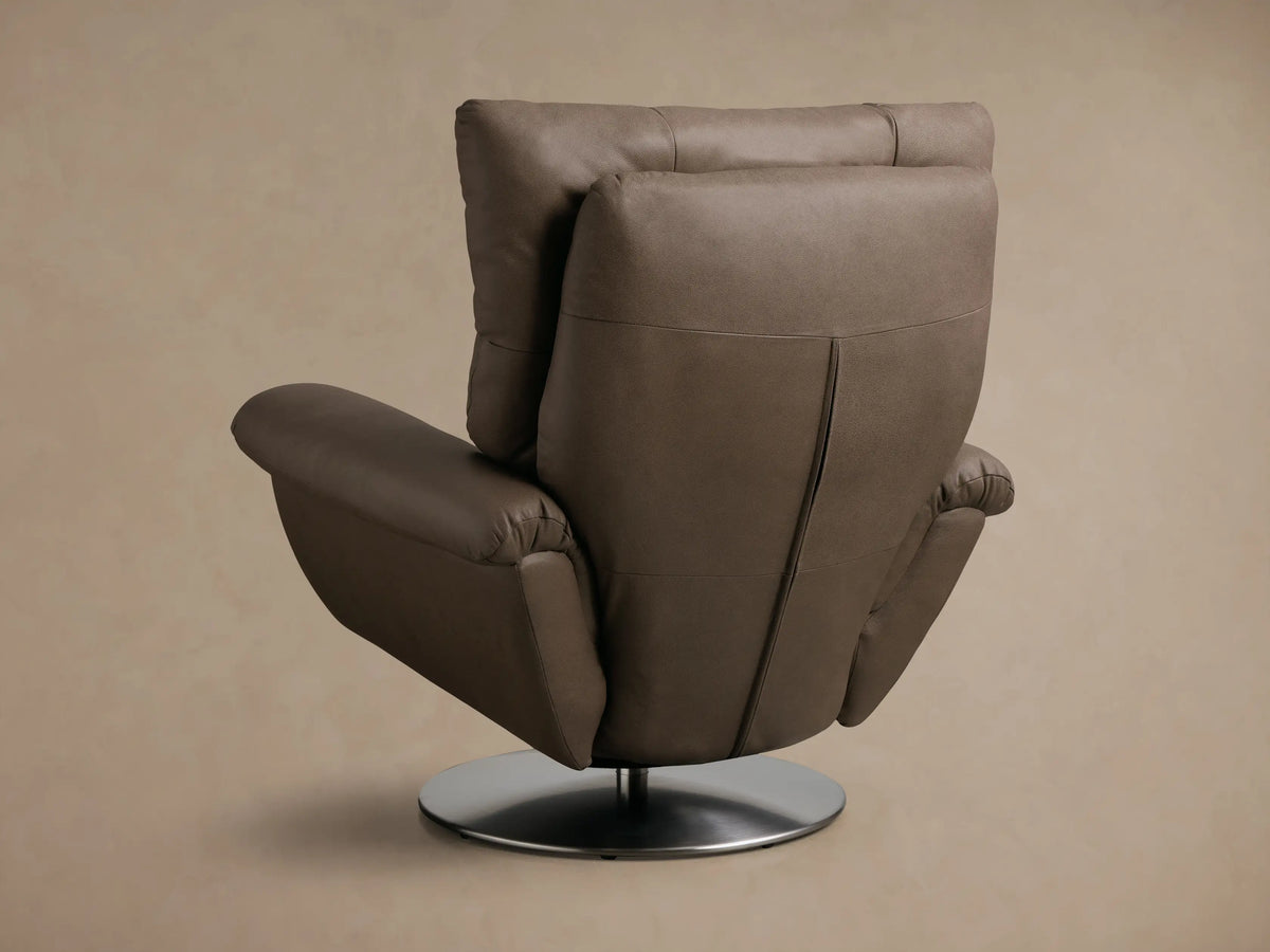 Close-up of the taupe pebbled leather armrest and segmented back of the Deacon Leather Swivel Recliner™.