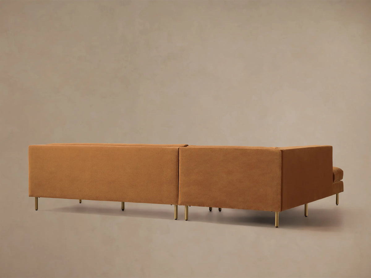 Rear view of the tan Malta Two-Piece Chaise Sectional featuring modern gold legs.