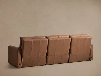 Warm brown Rowland Tailored Leather Modular Sofa recliner with an extended footrest, viewed from a side angle.