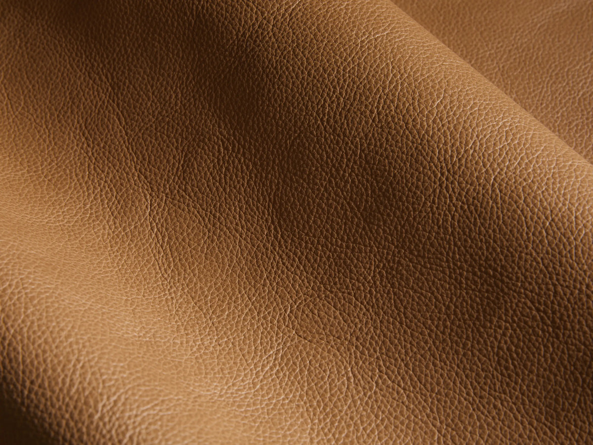 Close-up of the brown leather on the Rowland Tailored Leather Six-Piece Motion Sectional.