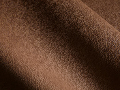Close-up of the brown textured leather on the Rowland Tailored Leather Six-Piece Motion Sectional.