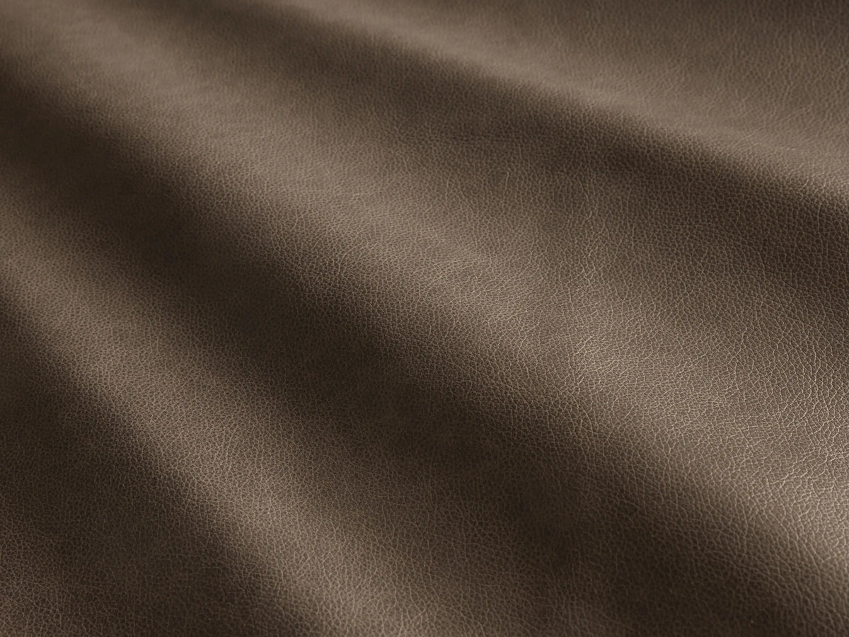 Close-up of the brown leather on the Rowland Tailored Leather Four-Piece Armless Motion Modular Sofa.