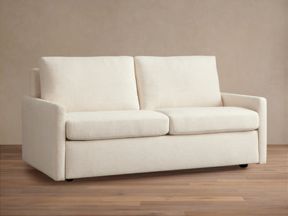 Kipton Luxury Sleeper Sofa in cream fabric, with clean lines, two cushions, and a sleek design, placed on wooden floor.