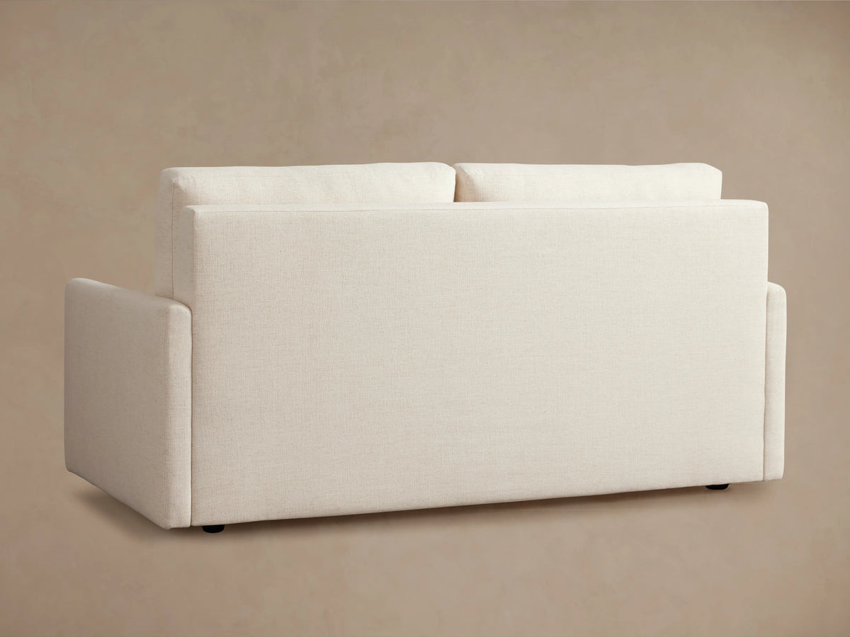 Kipton Luxury Sleeper Sofa shown in beige, partially unfolded with white mattress on black frame, set against a neutral background.