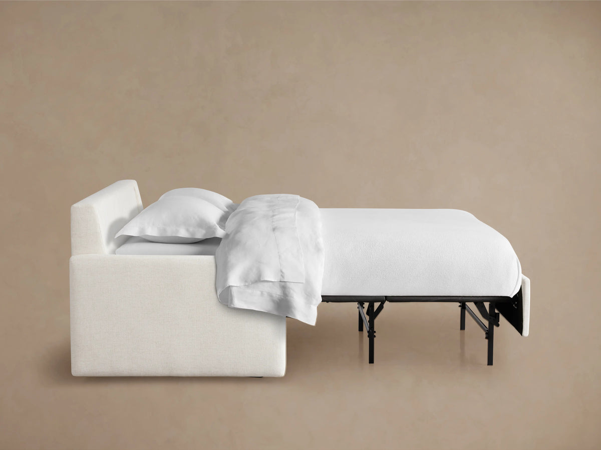 Back view of the Kipton Luxury Sleeper Sofa with light beige upholstery, featuring two back cushions and clean, minimalistic design.