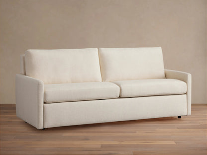 Kipton Slim Arm Luxury King Sleeper Sofa in Wiley Parchment, a light beige fabric, with slim arms, two seat and back cushions.