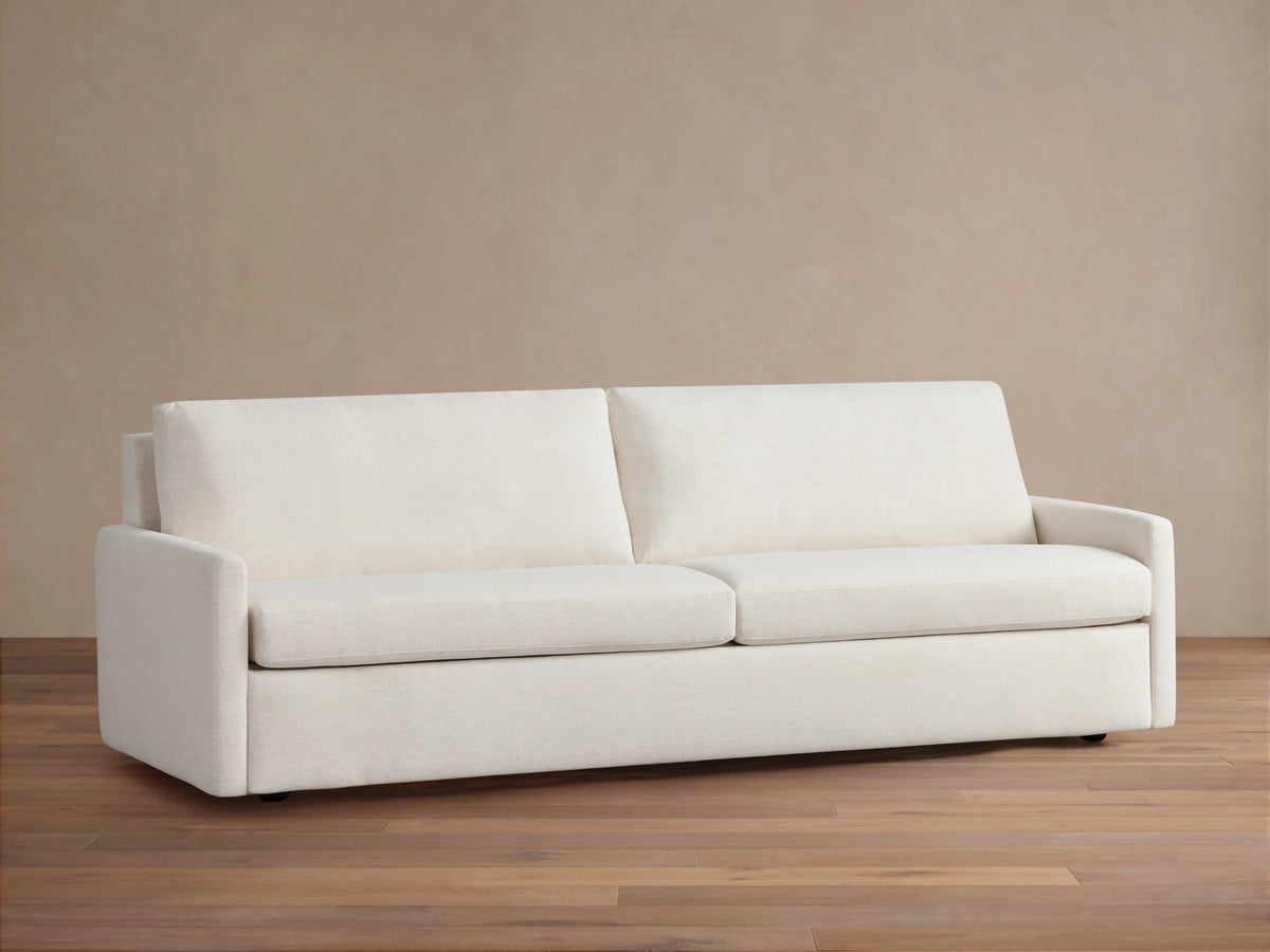 Kipton Luxury Sleeper Sofa in cream color, features a minimalist design with clean lines, two seat cushions, and two back cushions.