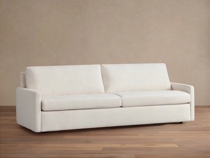 Kipton Luxury Sleeper Sofa in cream color, features a minimalist design with clean lines, two seat cushions, and two back cushions.