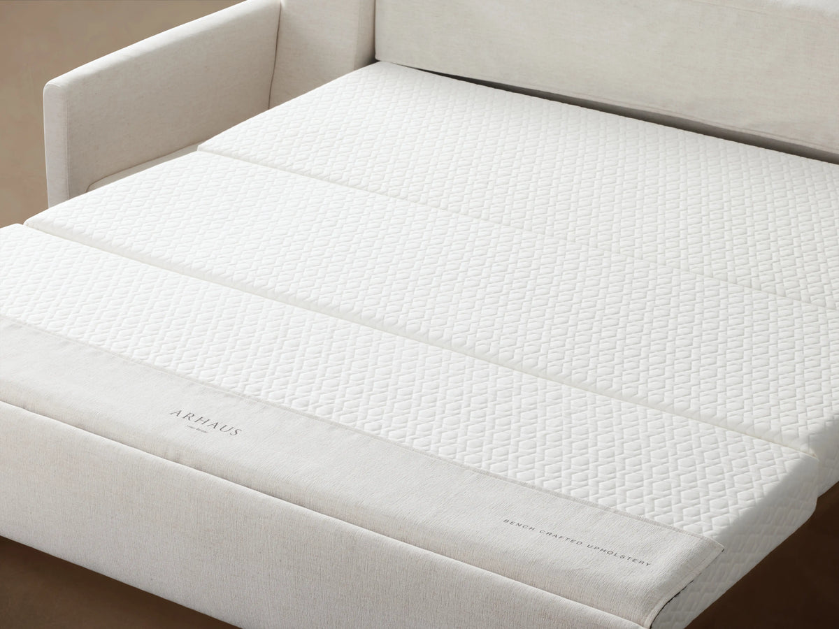 Kipton Luxury Sleeper Sofa in light beige fabric, featuring a sleek, modern design with straight arms and plush cushions.