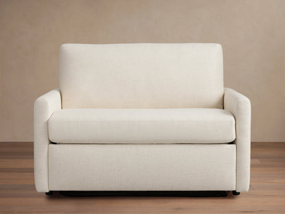 Kipton Slim Arm Luxury Twin Sleeper Chair in beige fabric, straight view. Features slim arms, plush seat, and back cushion on wooden floor.