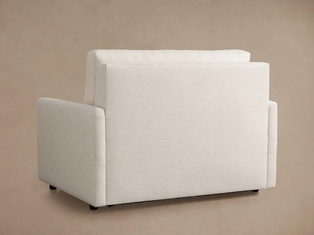 Kipton Slim Arm Luxury Twin Sleeper Chair with extended white mattress, quilted pattern, and beige upholstery; armrests on both sides.