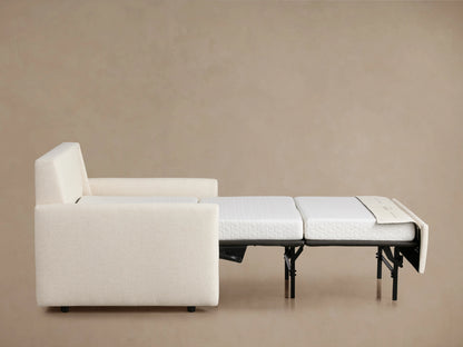 Kipton Slim Arm Luxury Twin Sleeper Chair in cream fabric, viewed from the back. Features slim arms and a plush backrest.
