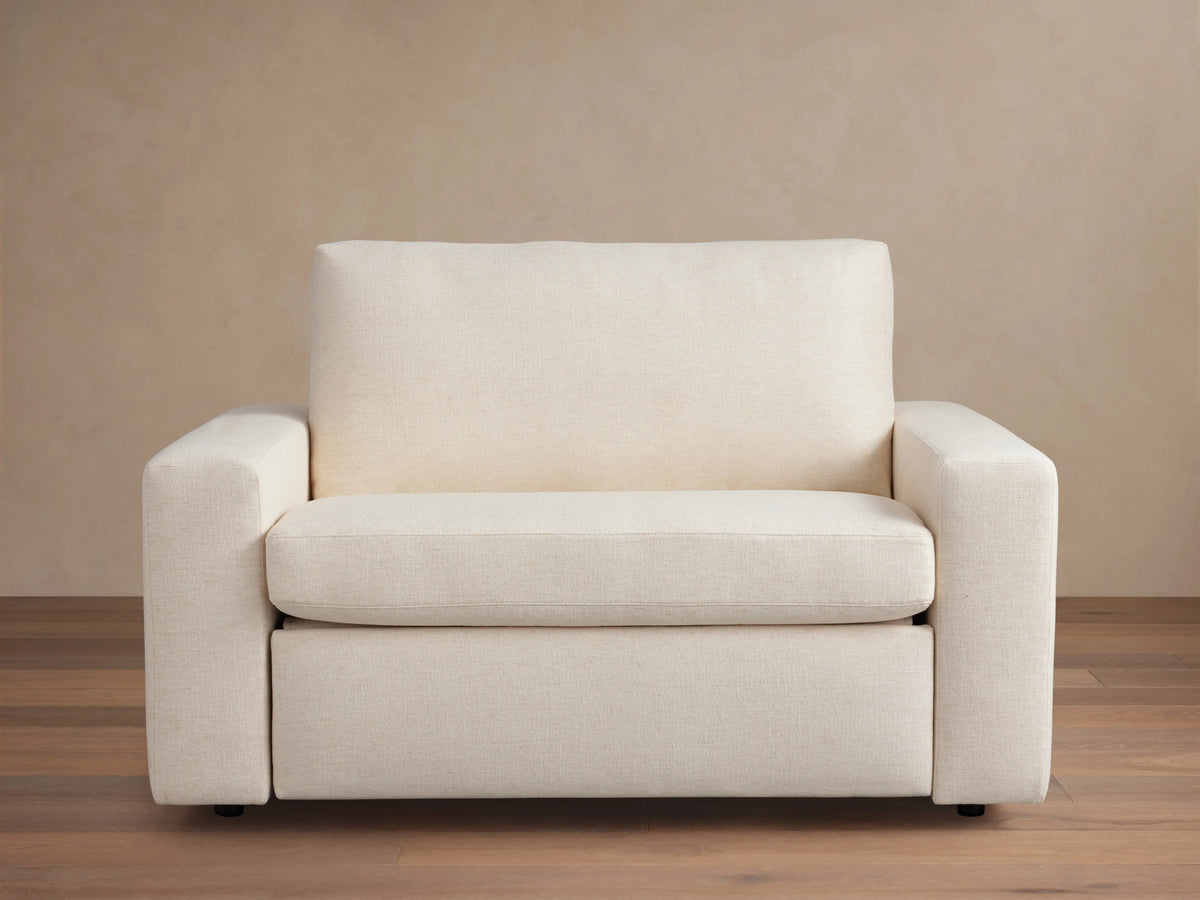Kipton Wide Arm Luxury Twin Sleeper Chair in cream fabric with a plush backrest, wide armrests, and a sleek, modern design.