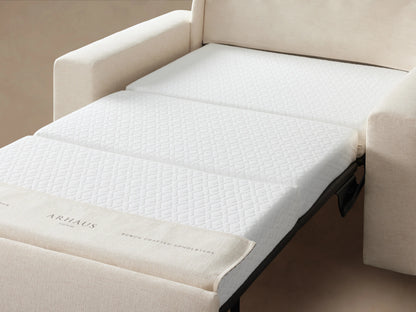 Kipton Wide Arm Luxury Twin Sleeper Chair in beige fabric, showcasing its broad arms, plush backrest, and seat cushion on a wood floor.