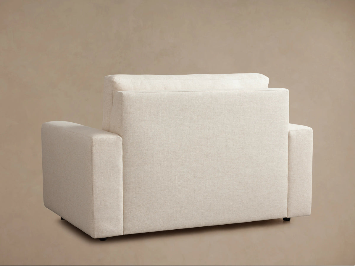 Kipton Wide Arm Luxury Twin Sleeper Chair with beige upholstery, extended to reveal a quilted white mattress.