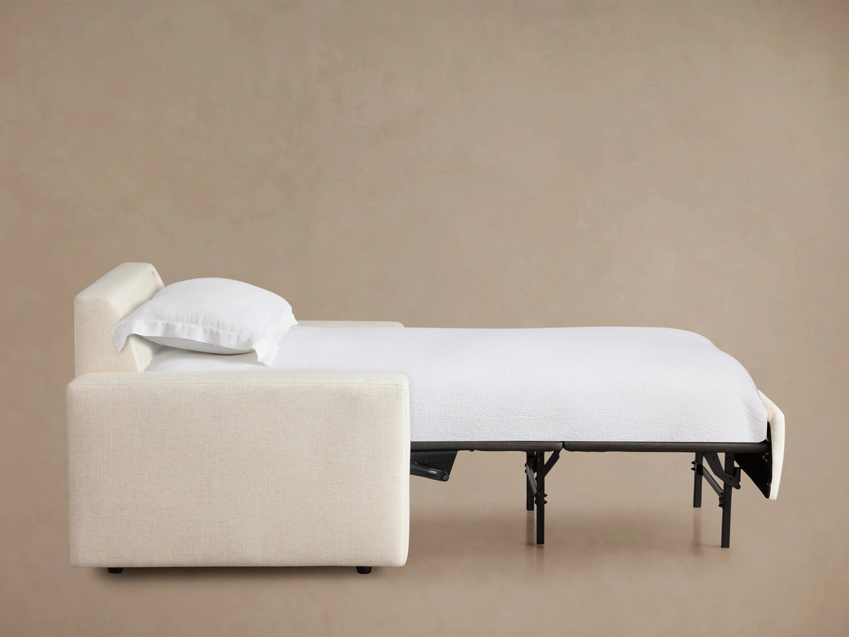 Kipton Wide Arm Luxury Twin Sleeper Chair in cream fabric, shown from the back. Features broad arms and a plush, squared backrest against a neutral background.