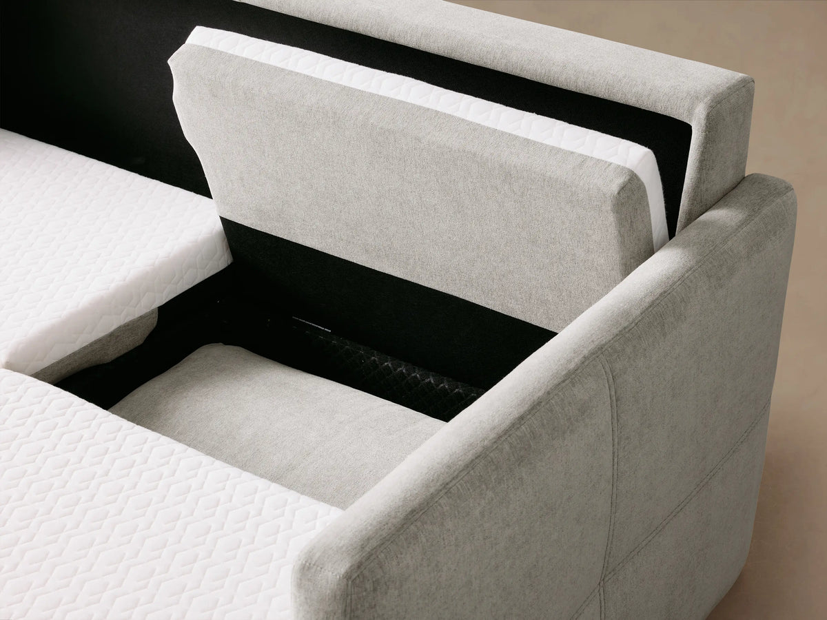 Back view of a light gray Reece Two-Piece Sleeper Chaise Sectional with an angled chaise on the right, against a neutral background.
