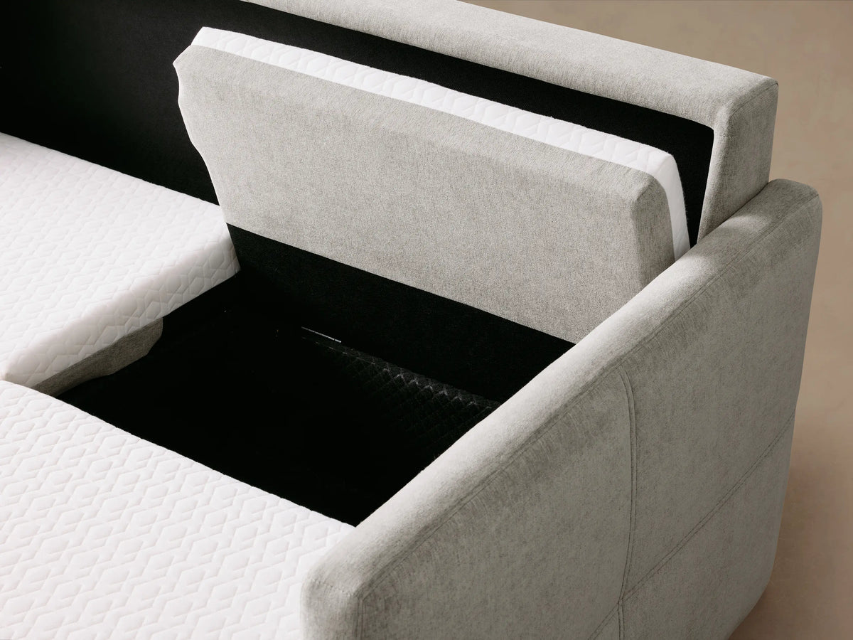 Reece Sleeper Chaise Sectional, light gray fabric, showing white quilted mattress pulled partially out from black interior.