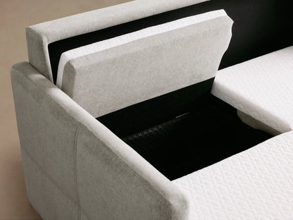 Back view of Reece Two-Piece Sleeper Chaise Sectional in light gray. Chaise arm with tufting on left, flat back panels.