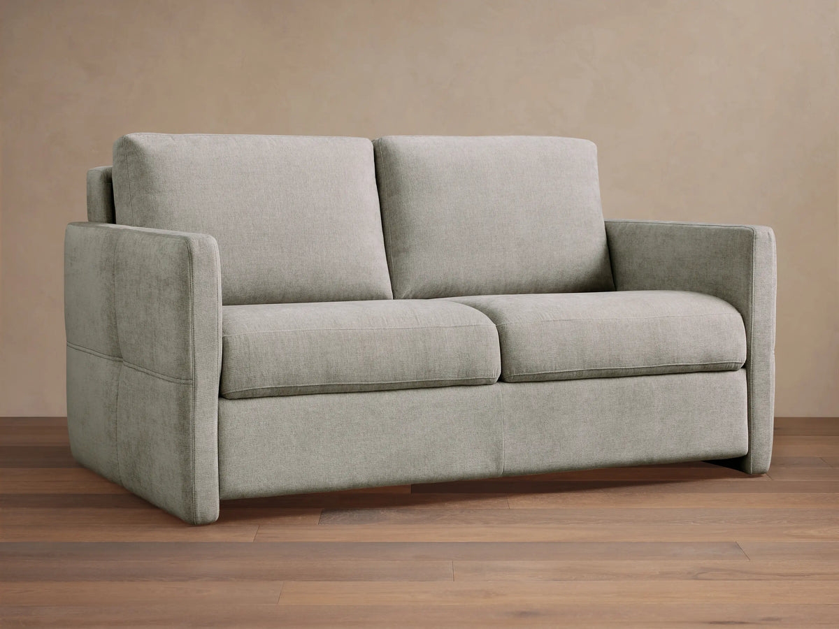 Light gray textured Reece Sleeper Sofa, front view. Features two seat and back cushions, with wide, squared armrests.