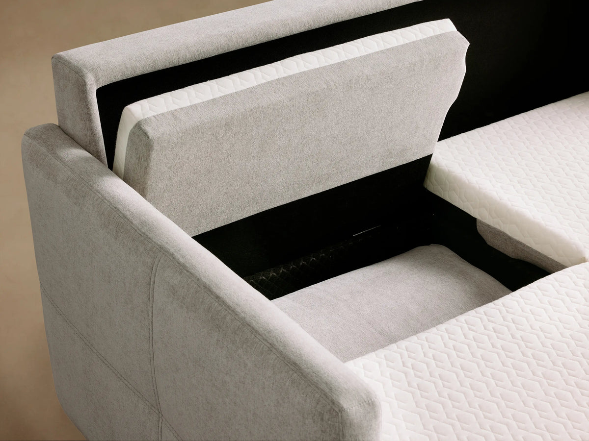 Reece Sleeper Sofa open, showcasing a white quilted mattress with quilted pattern, framed by gray upholstered sections.