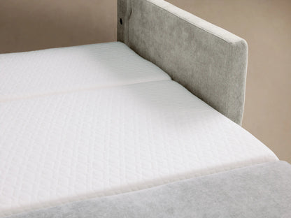 Reece Twin Sleeper Chair: light gray linen-textured sleeper chair with wide arms, soft cushions, on a wooden floor.