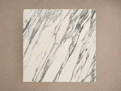Front view of the Saint Germain Square Bar Table with a white marble top with grey veining and a flared golden steel base.