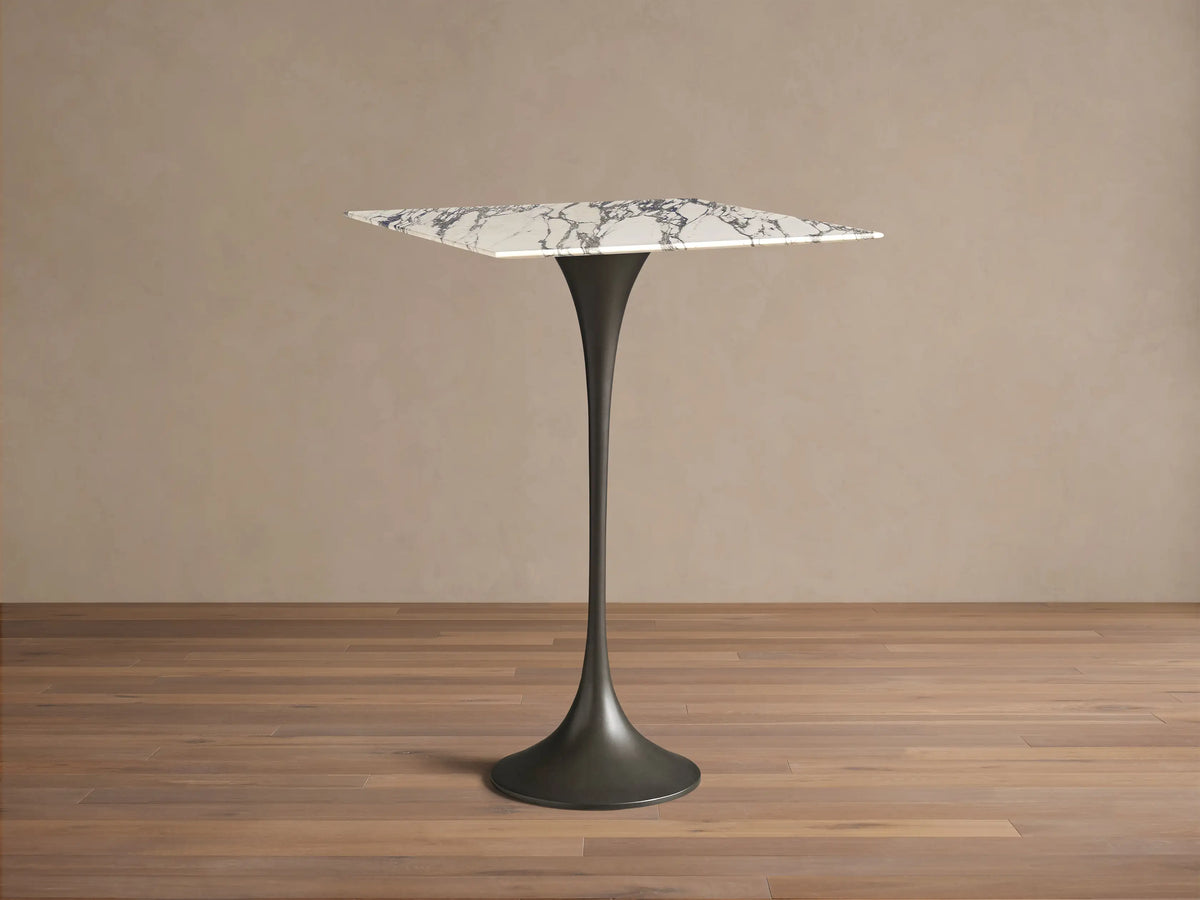 Front view of the Saint Germain Square Bar Table, featuring a white marble top with gray veining and a black pedestal base.