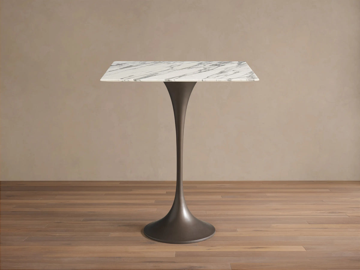 Front view of the Saint Germain Square Counter Table, with a white marble top and a dark flared metal base.