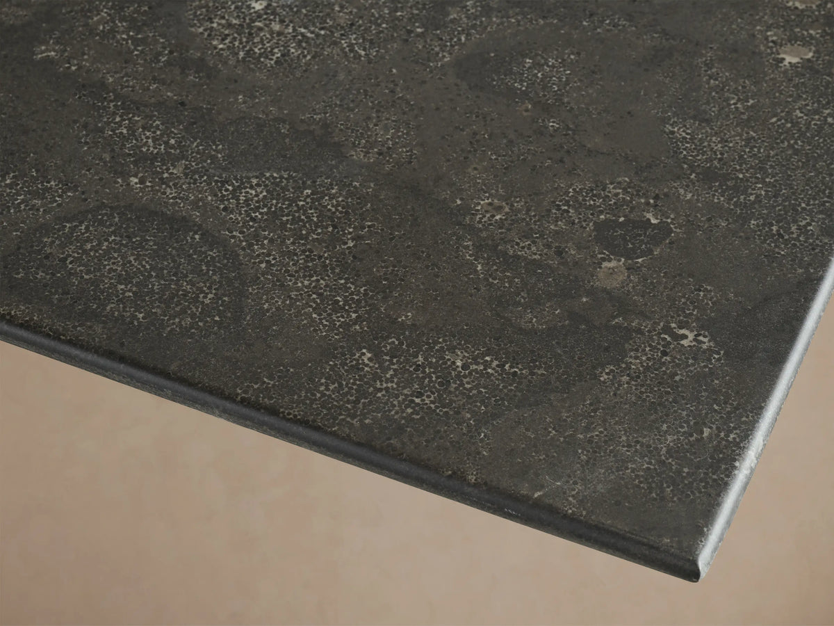 Top-down view of the dark grey textured stone tabletop of the Saint Germain Square Counter Table, showing natural variations.
