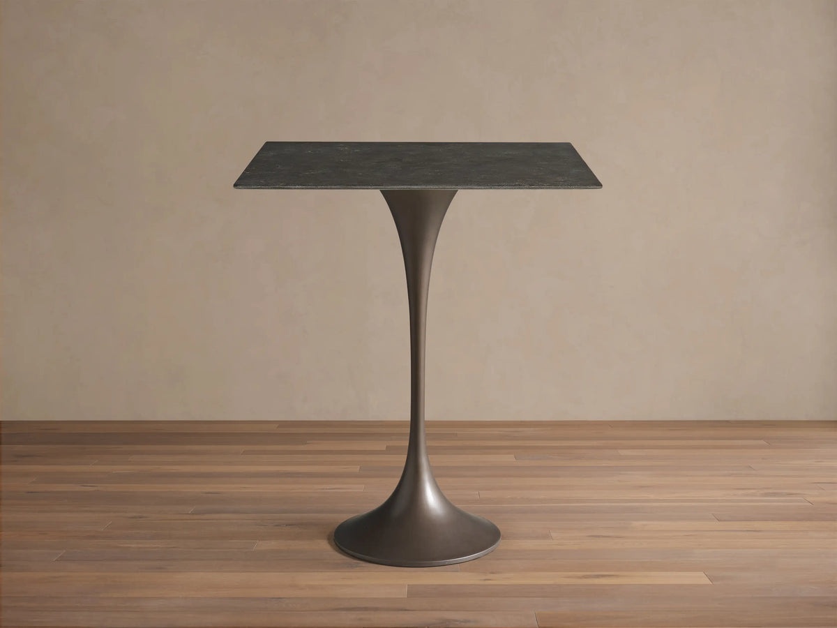 Top-down view of the dark gray, textured stone tabletop of the Saint Germain Square Counter Table.