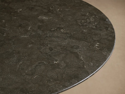 Front view of the dark charcoal stone Saint Germain Round Stone Dining Table with Toulouse Base, featuring a black conical wood base.