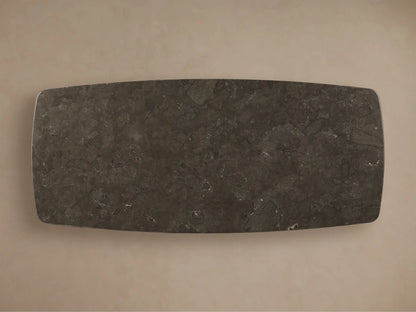 Front view of the Saint Germain Stone Dining Table with Toulouse Base. Dark honed stone top with rounded edges on a dark wood block base.