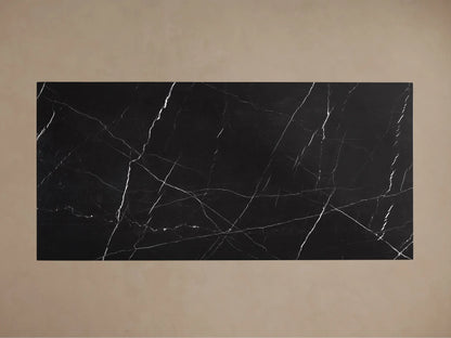 Top view of rectangular black marble slab with swirling white veins.